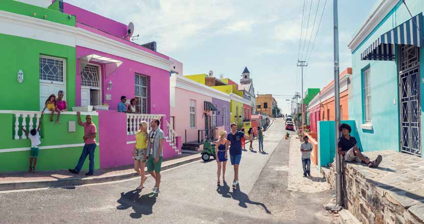 people walking in a colourful village